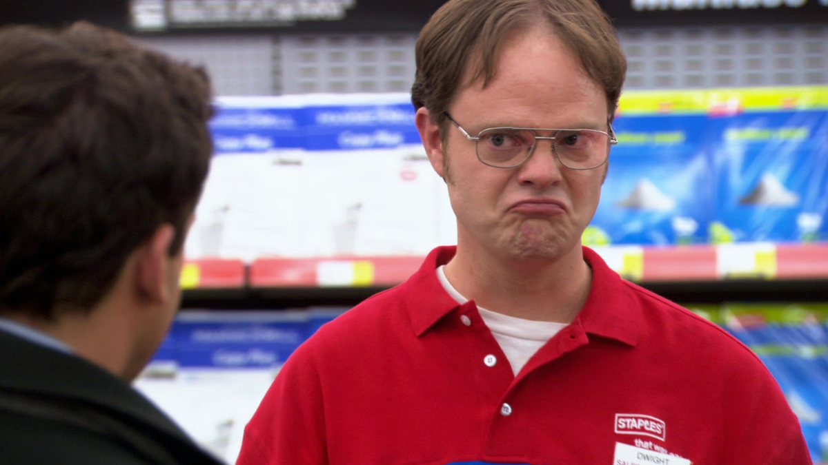 Foto Dwight dari 'The Office' dengan ekspresi kesal di wajahnya.