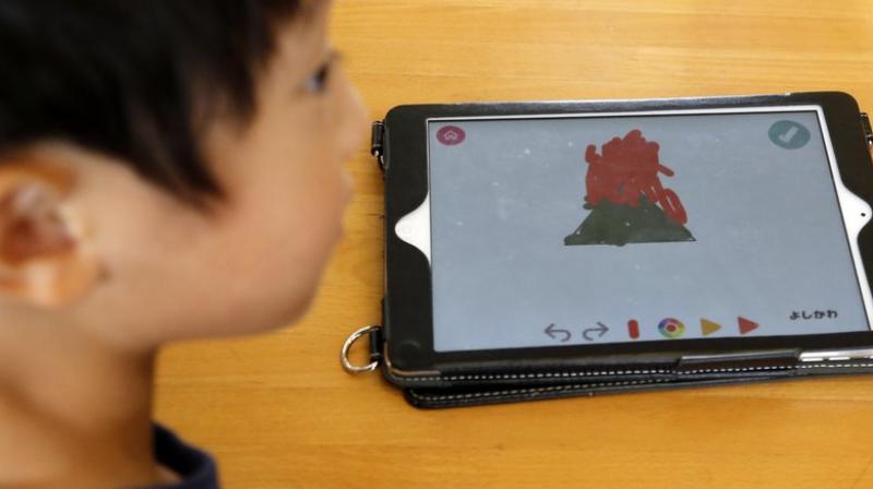 In a recent session, children got a triangle image on their iPads and were asked to draw on it with digital colours, store that image, and draw another one to create a two-screen story. (Photo: AP)
