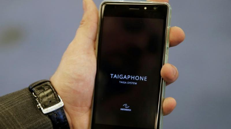 A man holds a TaigaPhone, a brand new smartphone created by InfoWatch Group, during a presentation in Moscow on September 22, 2017. (Photo: AFP)